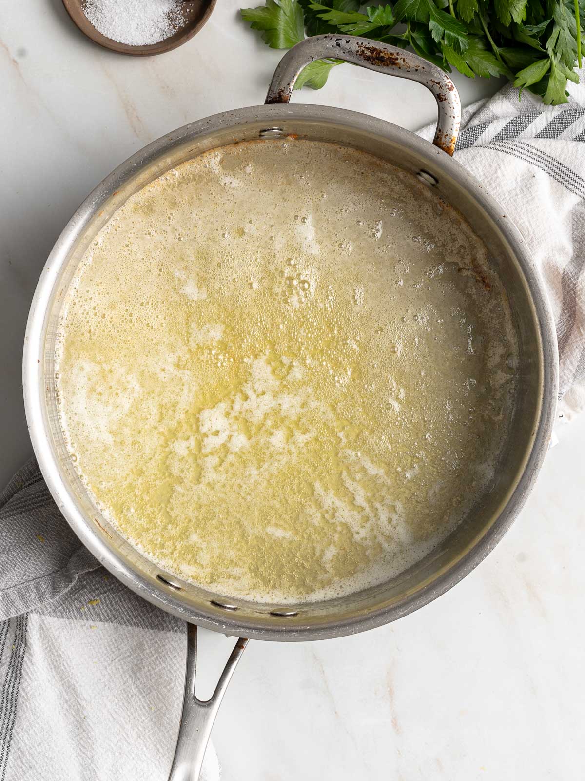 Alfredo sauce ingredients on a pot.