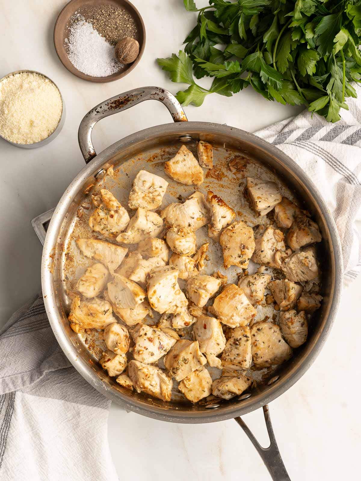 Cooked chicken cuts in a pot.