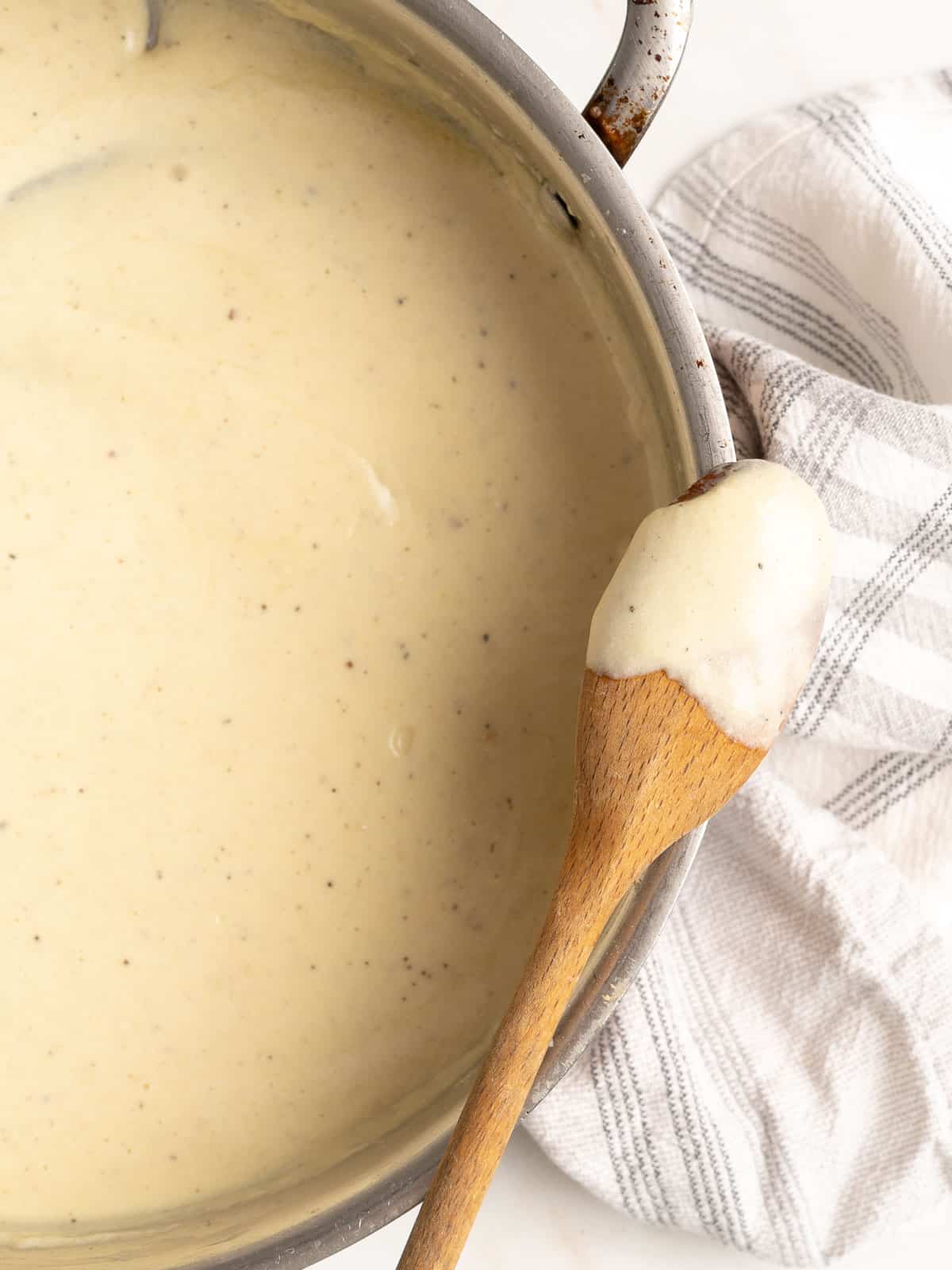 Chicken alfredo sauce in a pot.