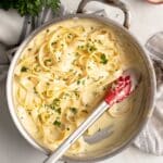 Gluten-free pasta with alfredo sauce in a pot.