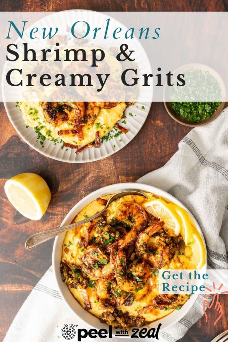 Cajun shrimp and grits served in a dish with lemon slices.