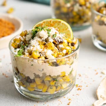 Mexican corn in a cup with a lime wedge.