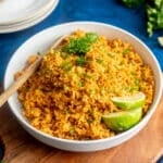 Spanish rice in a bowl with lime slices.