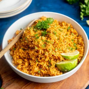 Spanish rice in a bowl with lime slices.