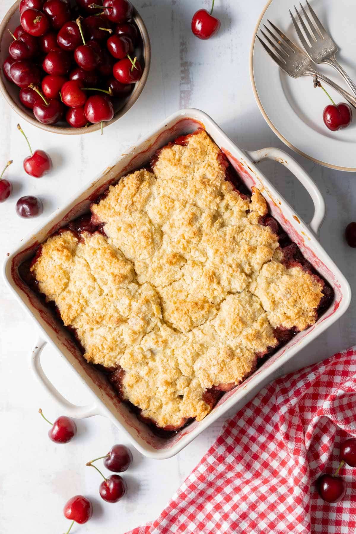 Freshly baked gluten-Free Cherry Cobbler in a baking dish place on the countertop.