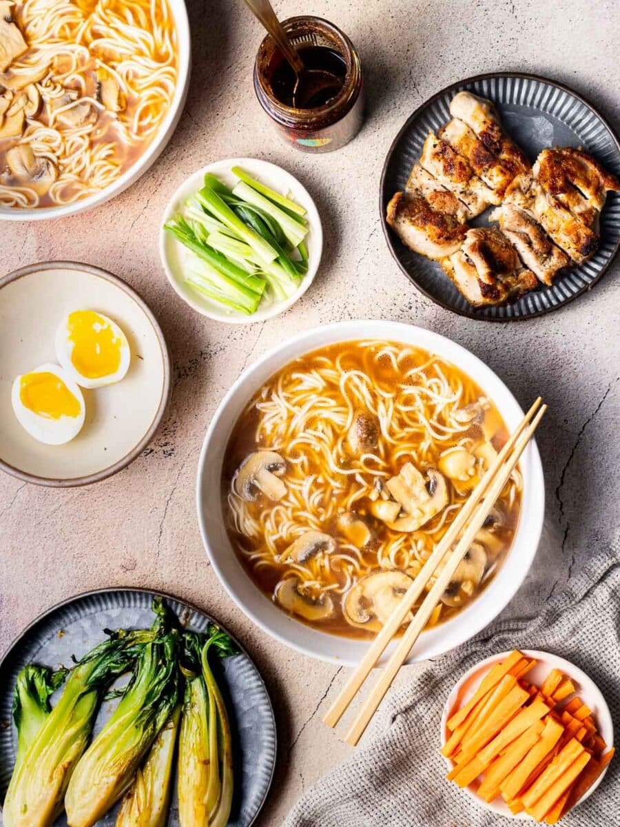 Ramen in the bowl along with the cooked vegetables displayed on the table.
