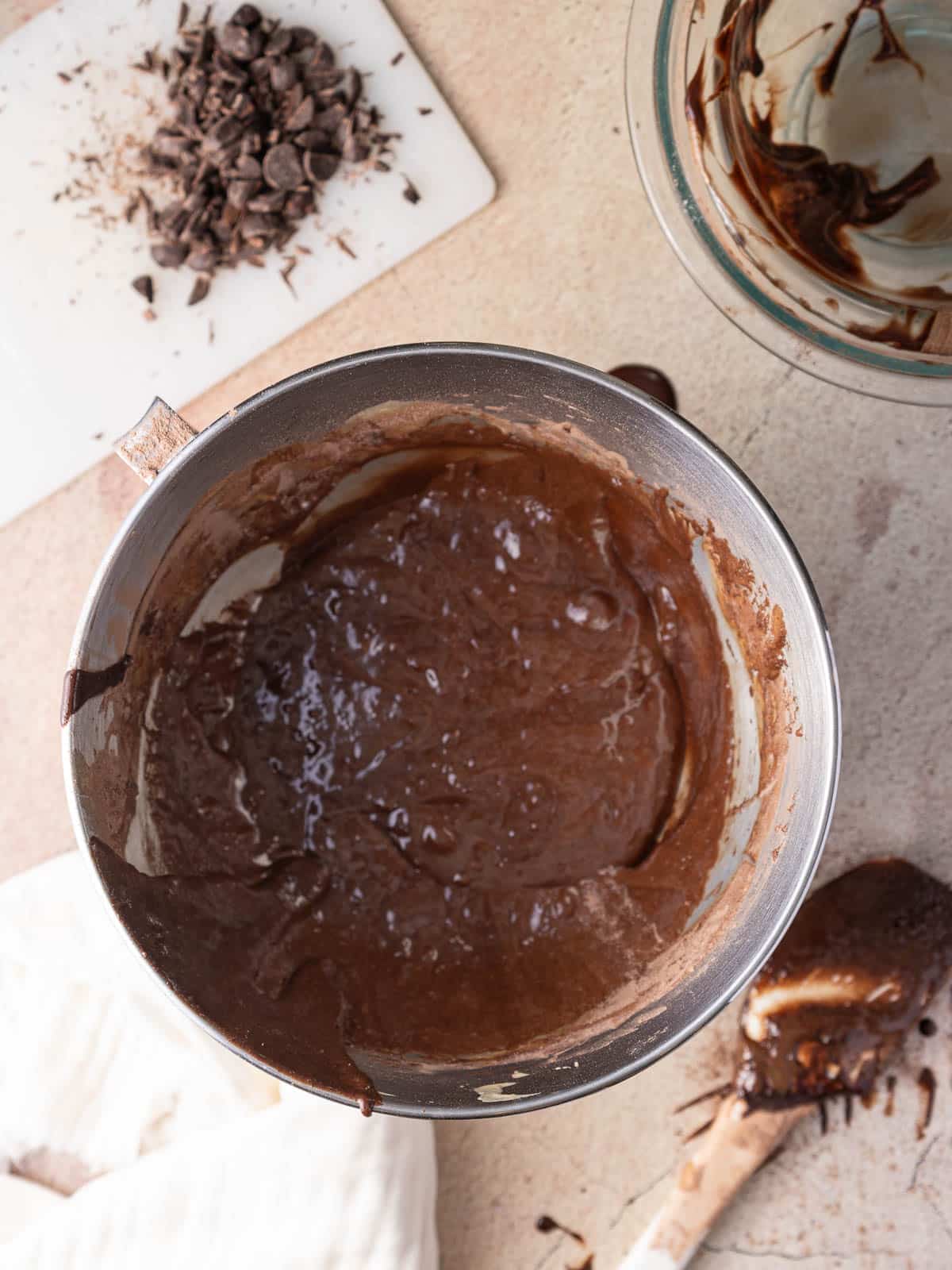 Chocolate ganache in the mixing bowl place on top of the table.