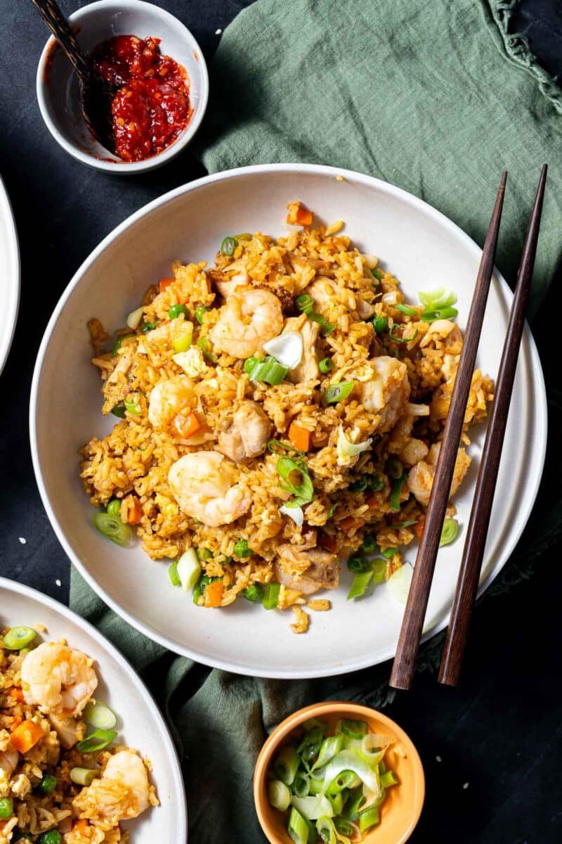Shrimp and chicken fried rice served in a bowl, set on the table.