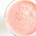 Strawberry tahini smoothie in a glass.