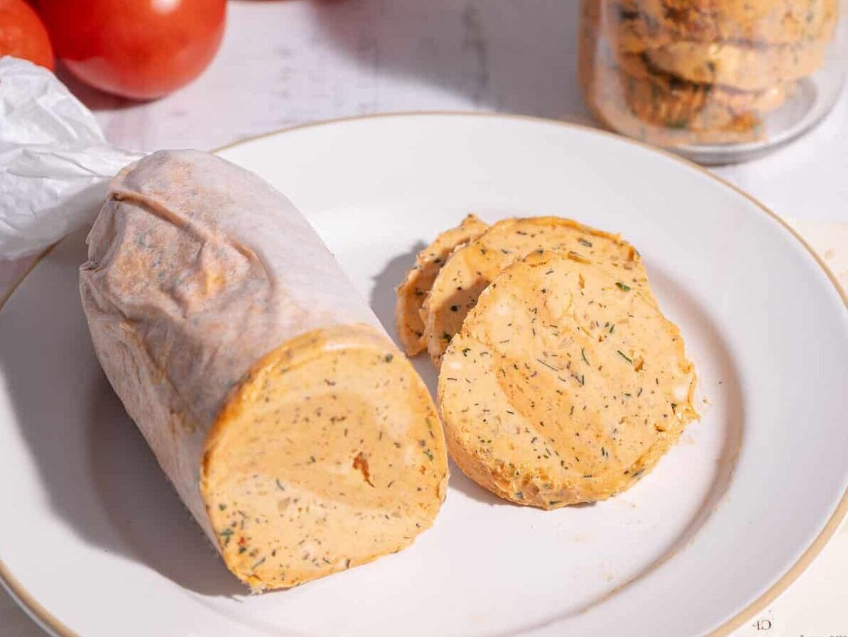 Tomato Butter in a glass and tomato butter wrap in a parchment paper.