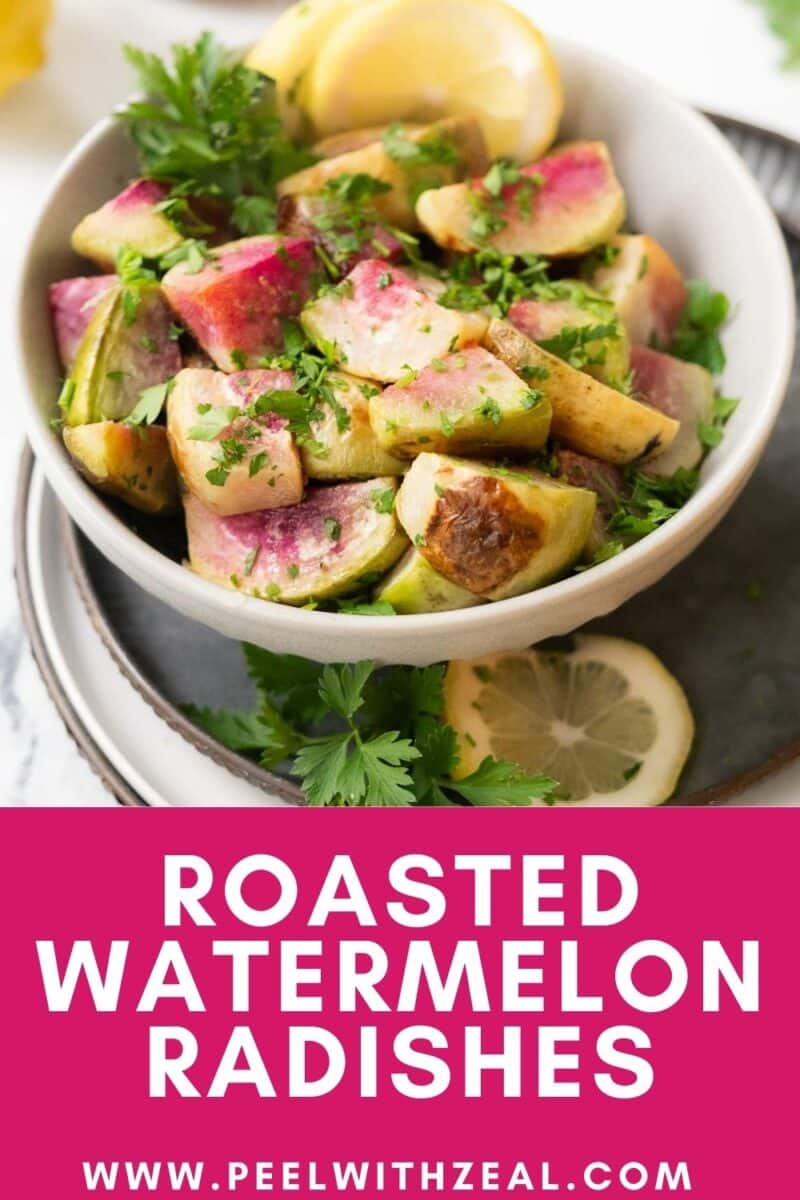 Roasted water melon radish on a salad bowl over a stack of various dinner plates.