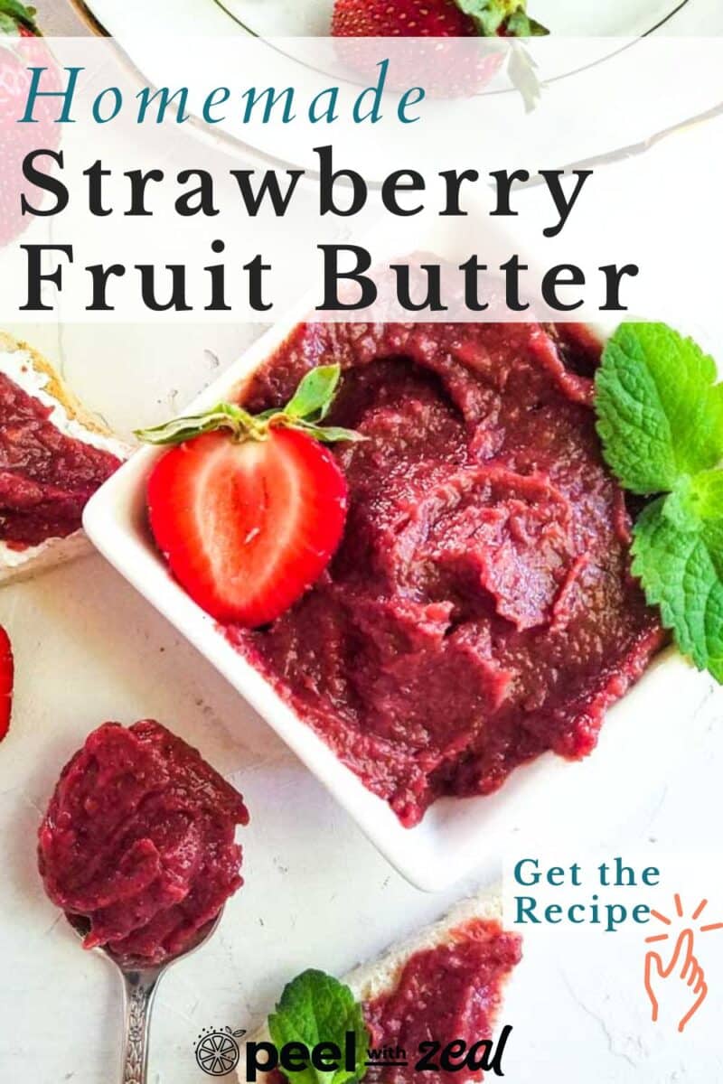 A bowl of homemade strawberry fruit butter, garnished with a slice of strawberry and fresh mint.