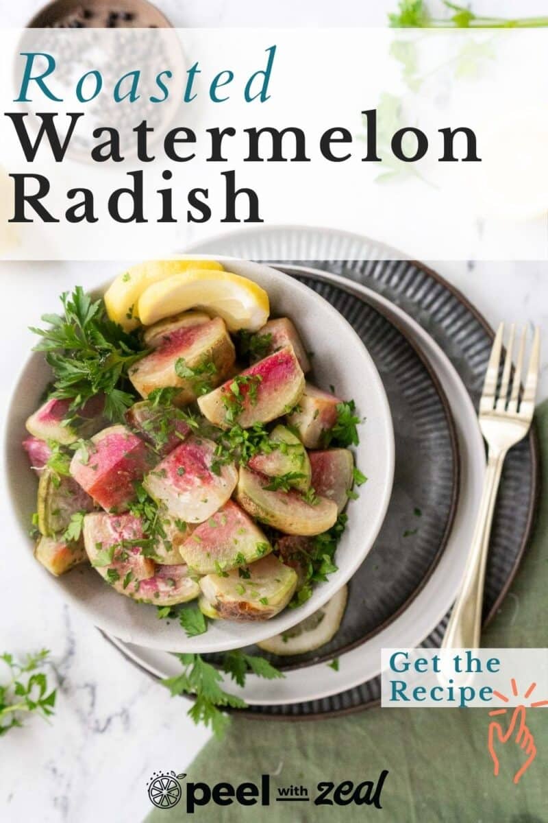 Roasted watermelon radish on a salad bowl over a stack of dinner plates resting on the table.