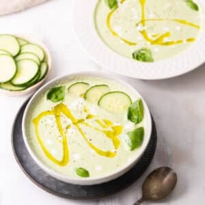 Cucumber soup served in a bowl garnished with fresh basil.