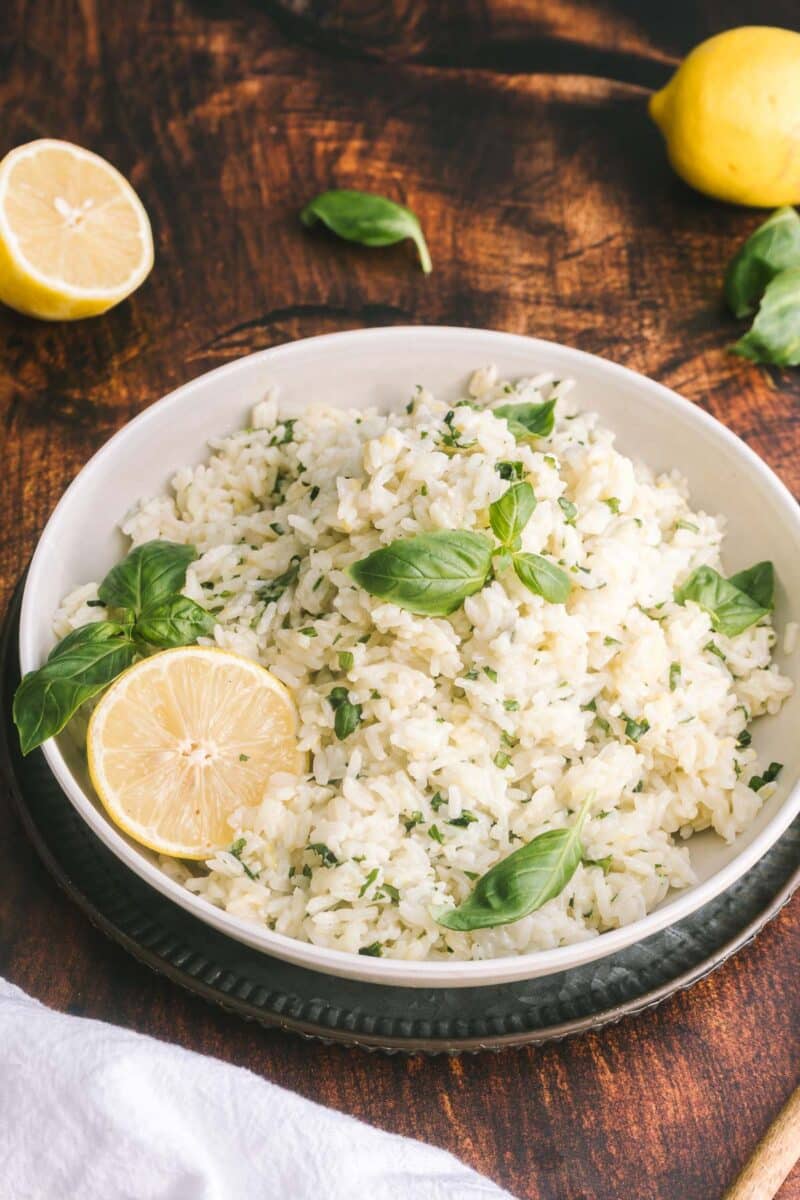 A lemon basil rice served on a shallow platter resting on the table.