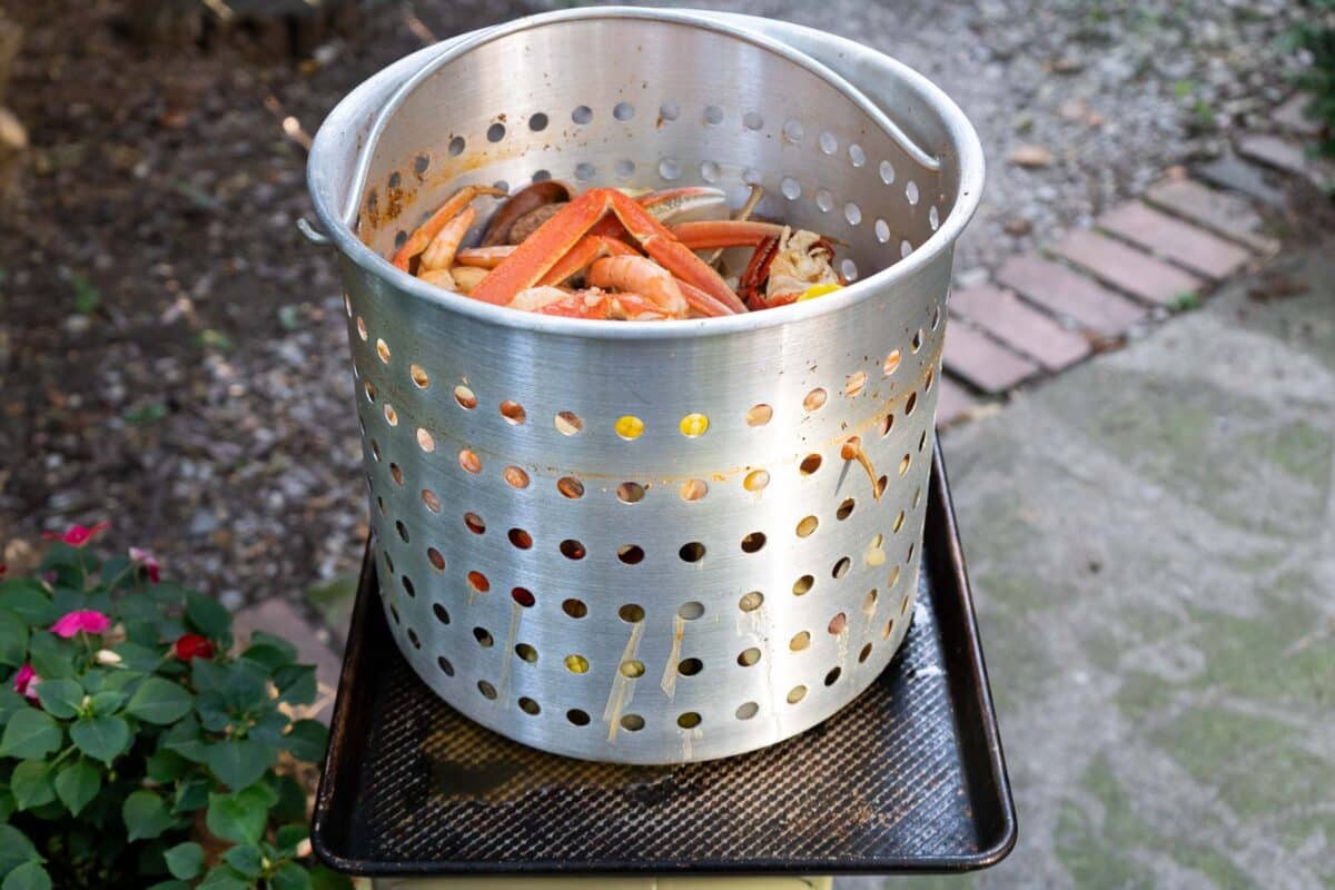 Cajun Seafood Boil in a bucket strainer.