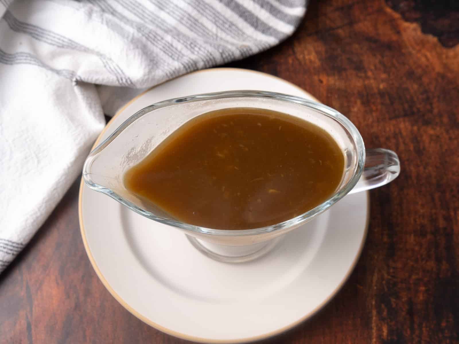 A Cajun Turkey gravy is being served on a gravy dispenser.