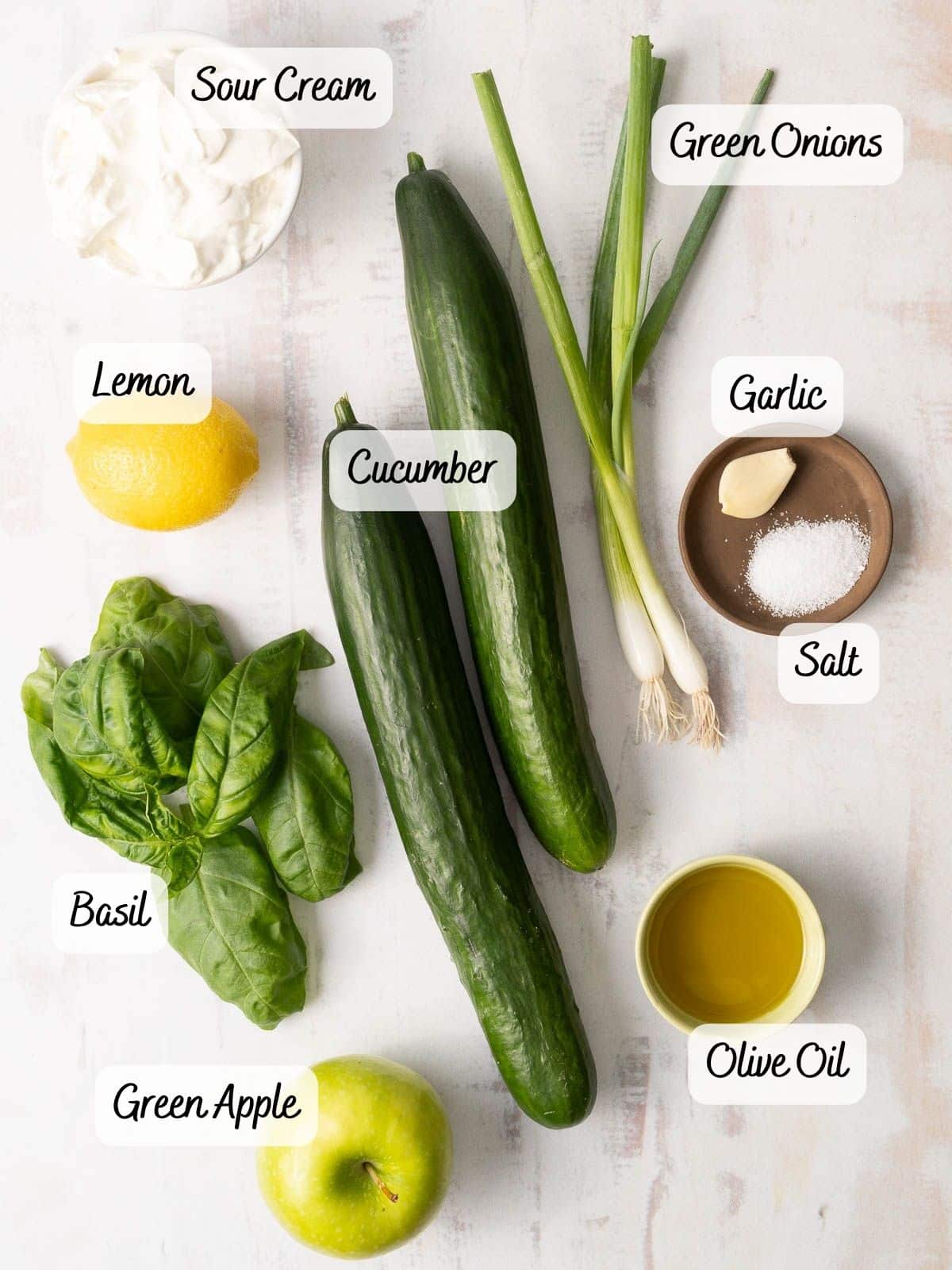 Cucumber soup ingredients being displayed in a white countertop.