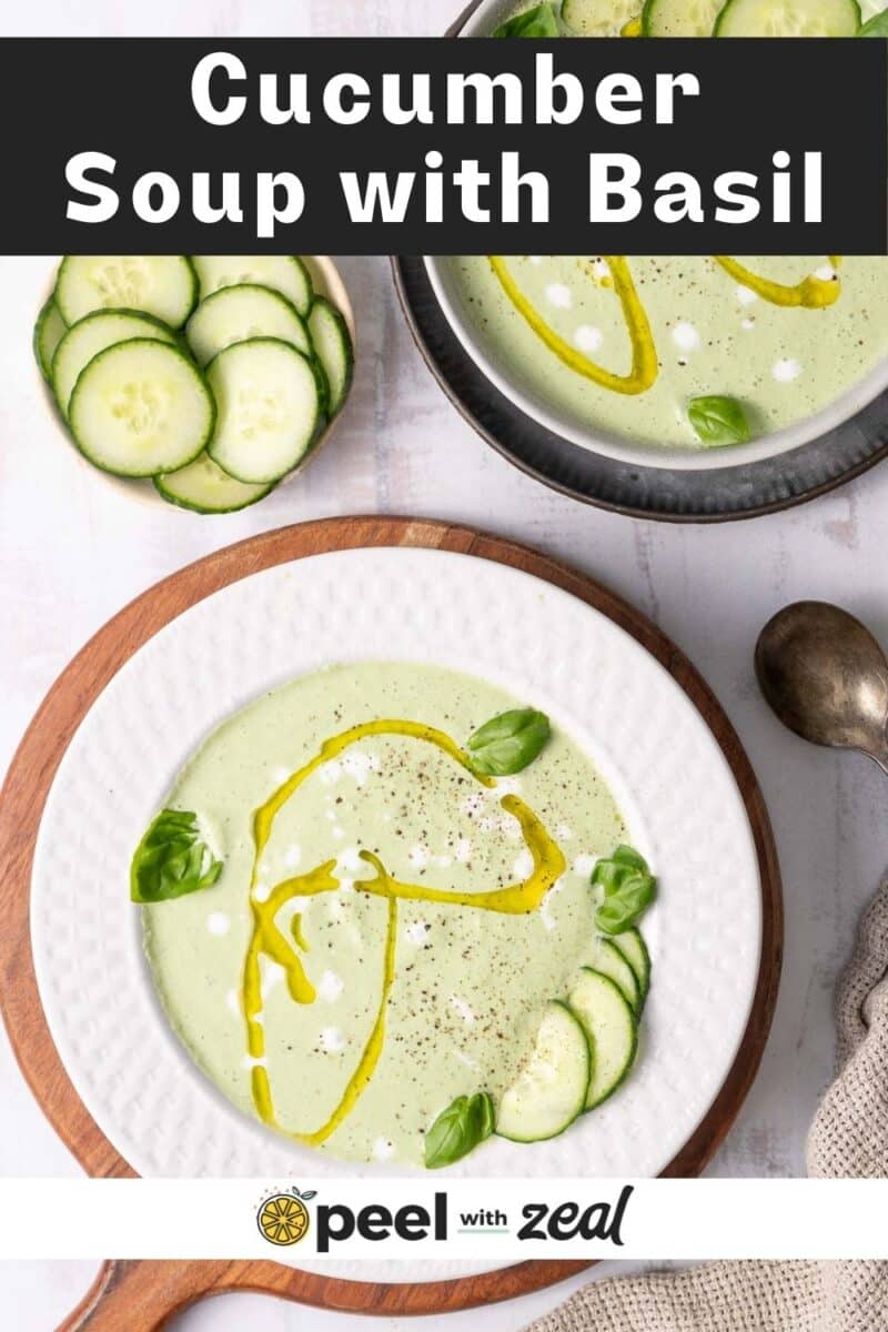 Cucumber soup topped with fresh basil served in a soup bowl placed on the table.