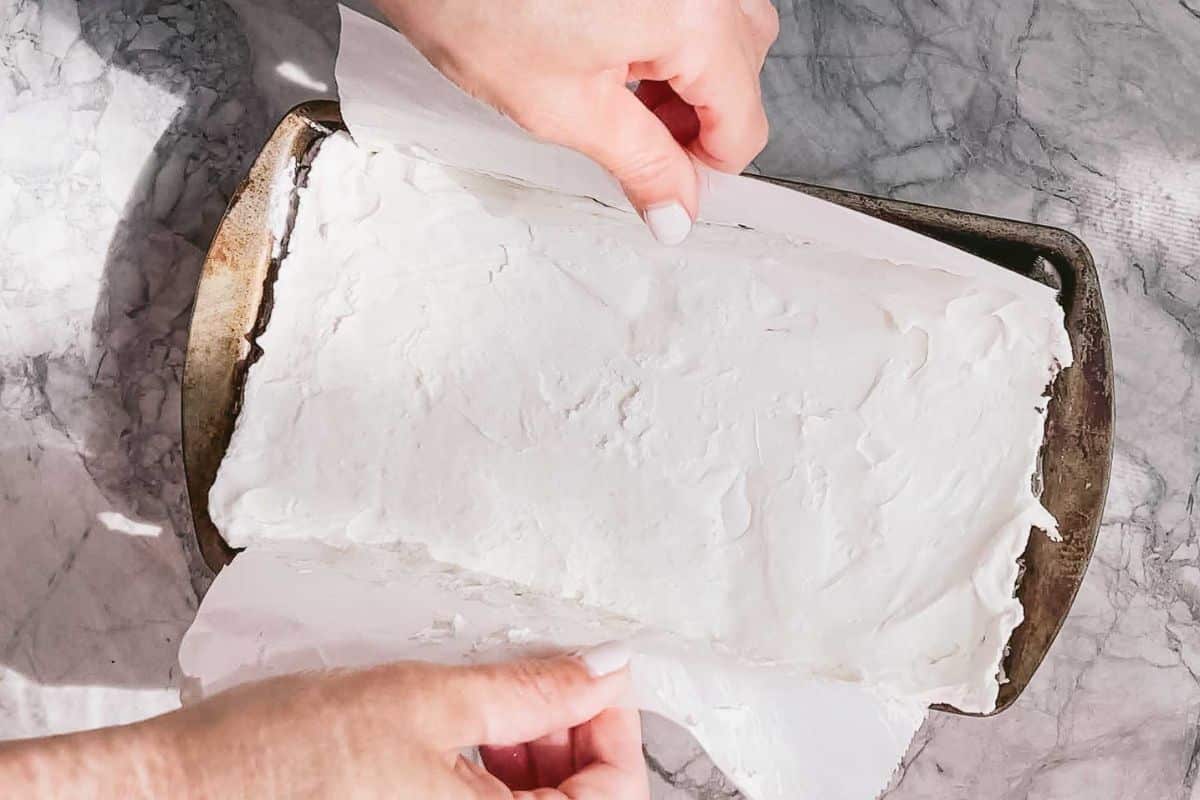 Parchment paper with cream fillings in a baking sheet pan.