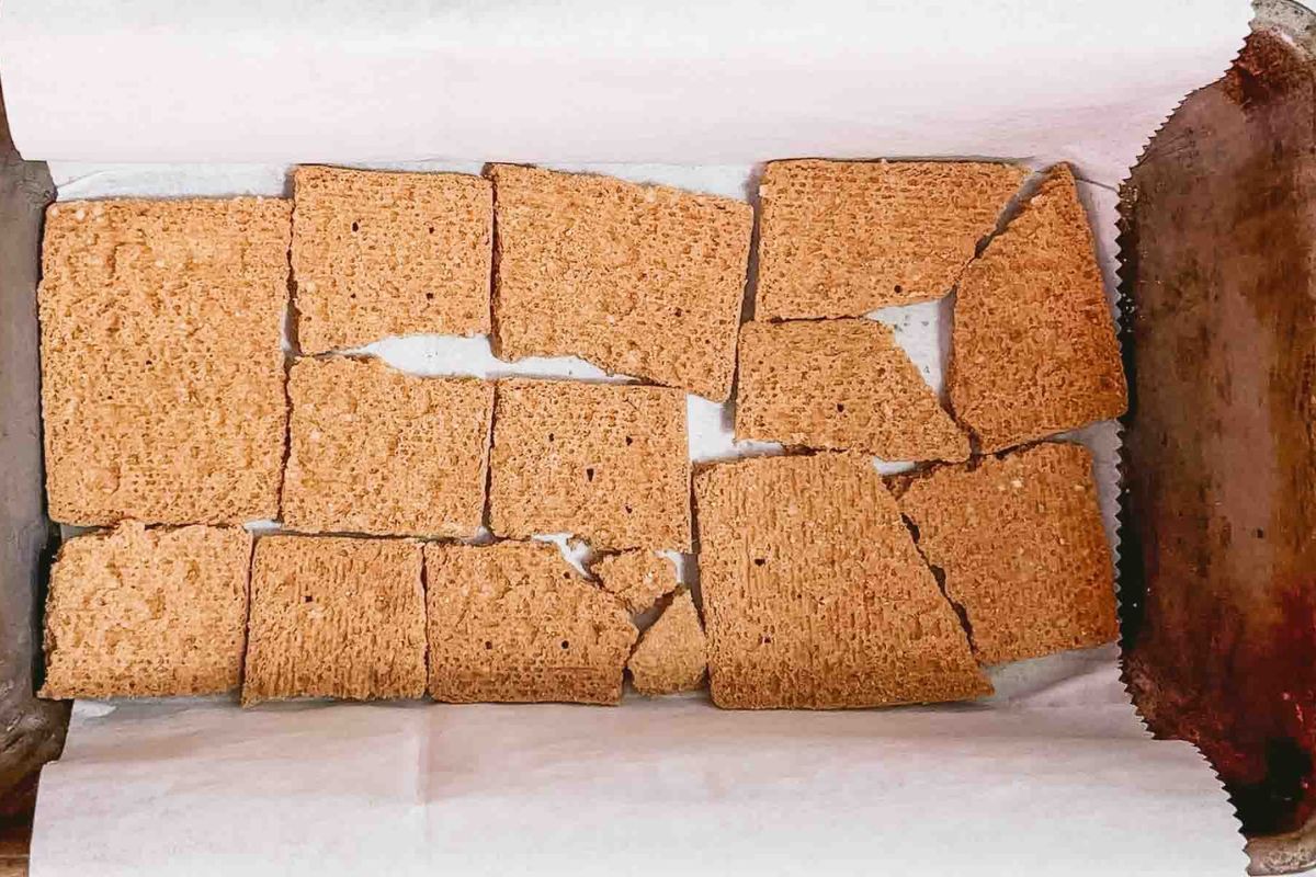 Layering crackers in a baking dish.