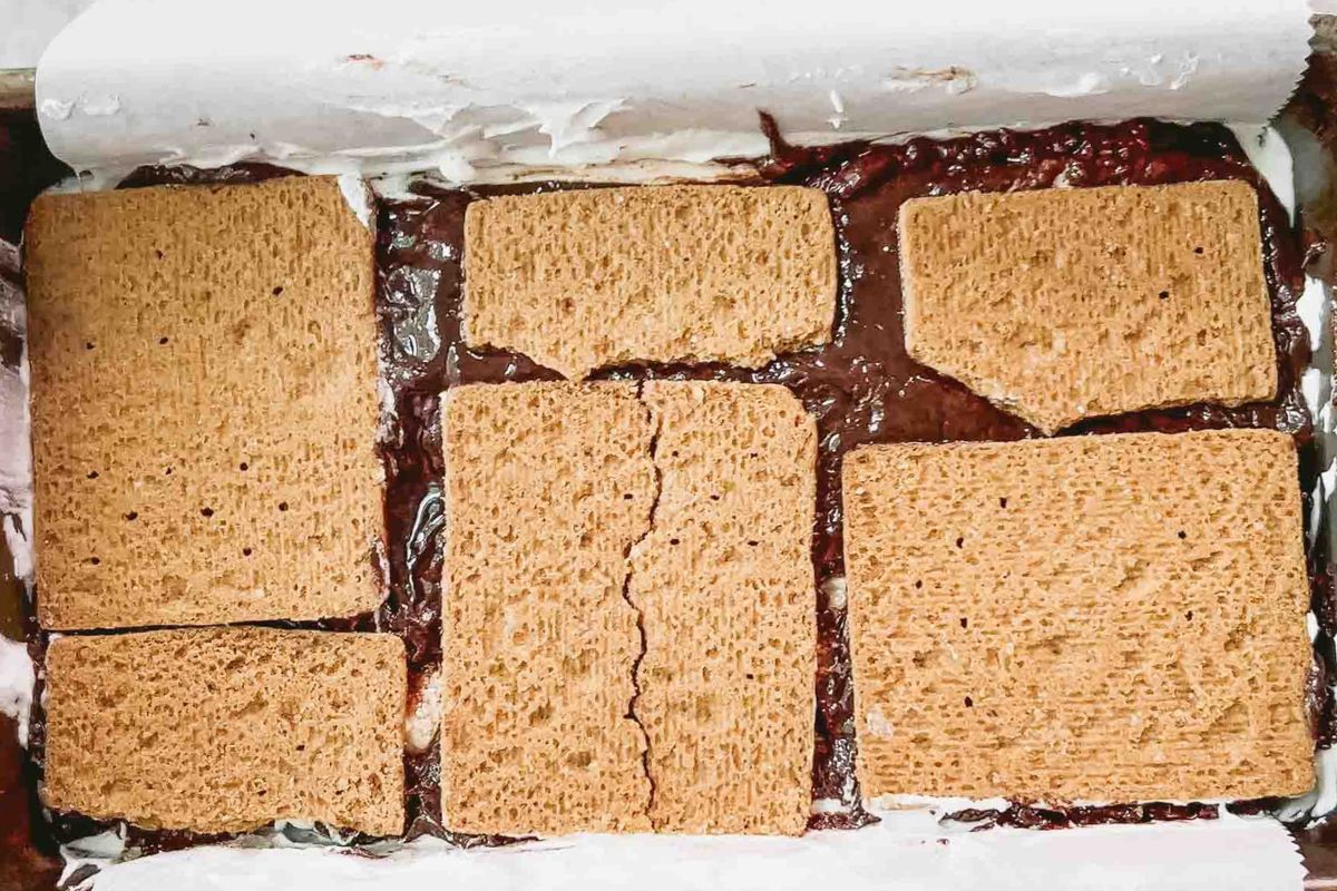 A layered crackers and fillings in a baking dish.
