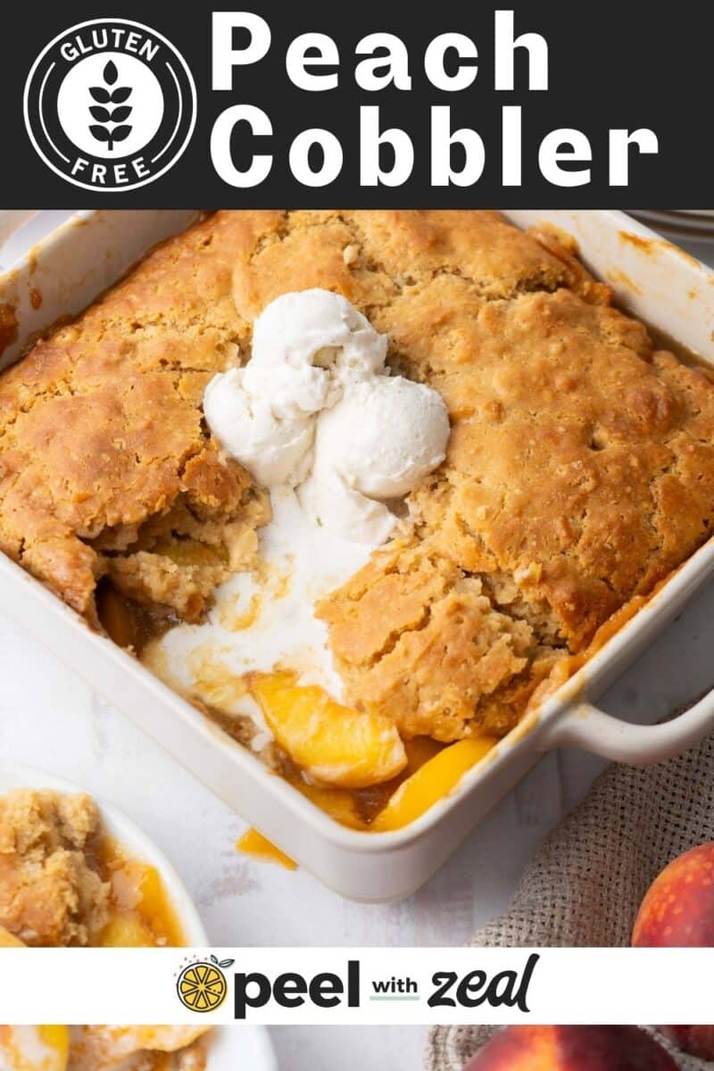Freshly baked Peach Cobbler in a baking dish topped with vanilla ice cream.
