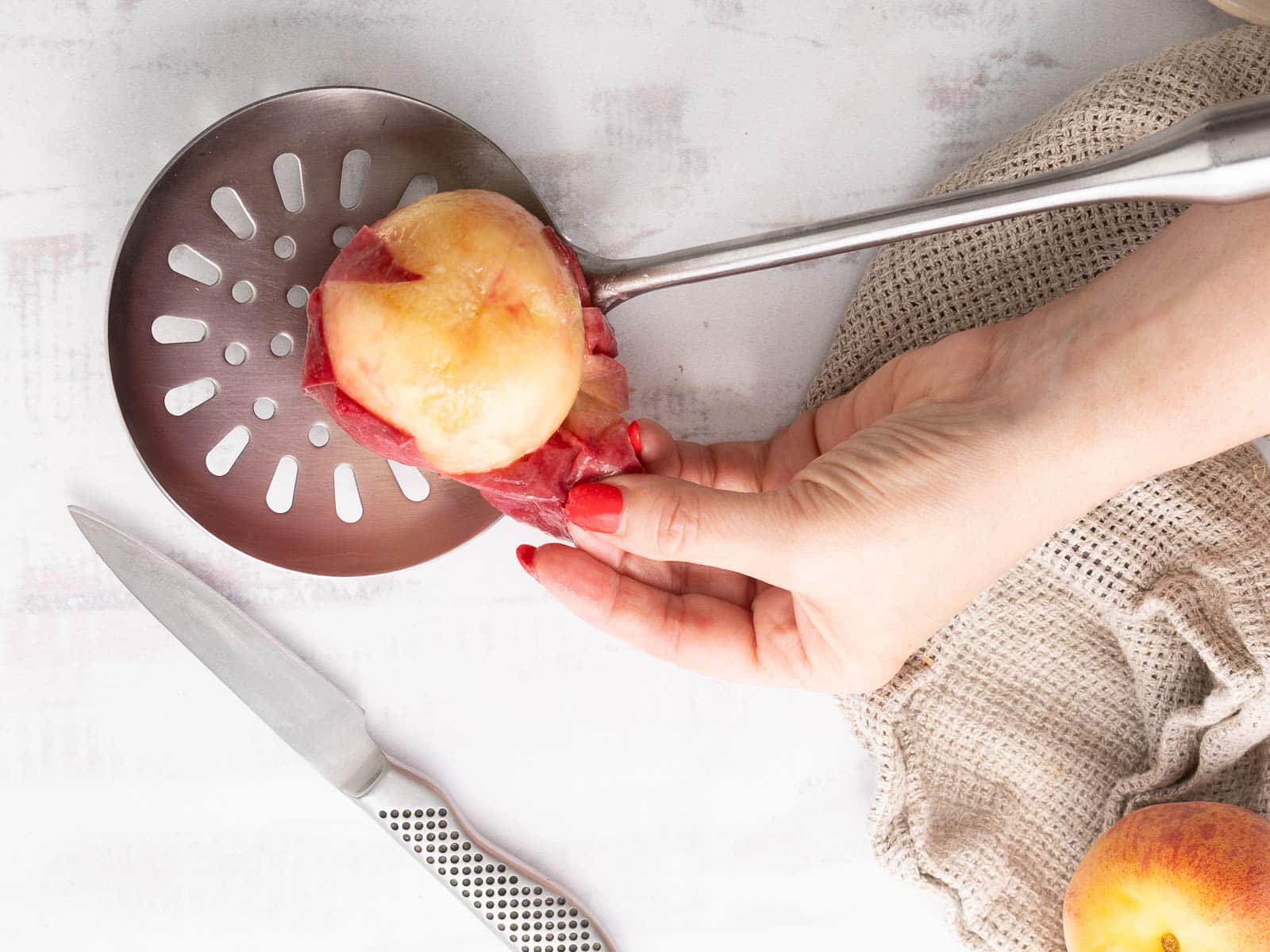 Peach fruit being peeled.