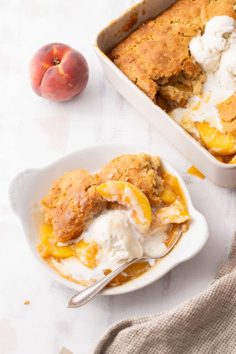 A portion of peach cobbler served on a fruit bowl.