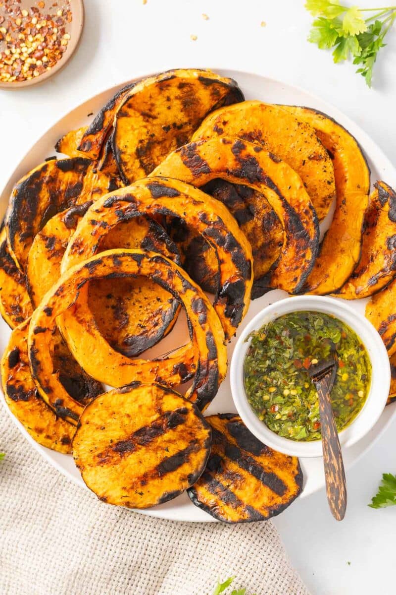 A portion of Grilled Butternut Squash being served on the dinner plate.