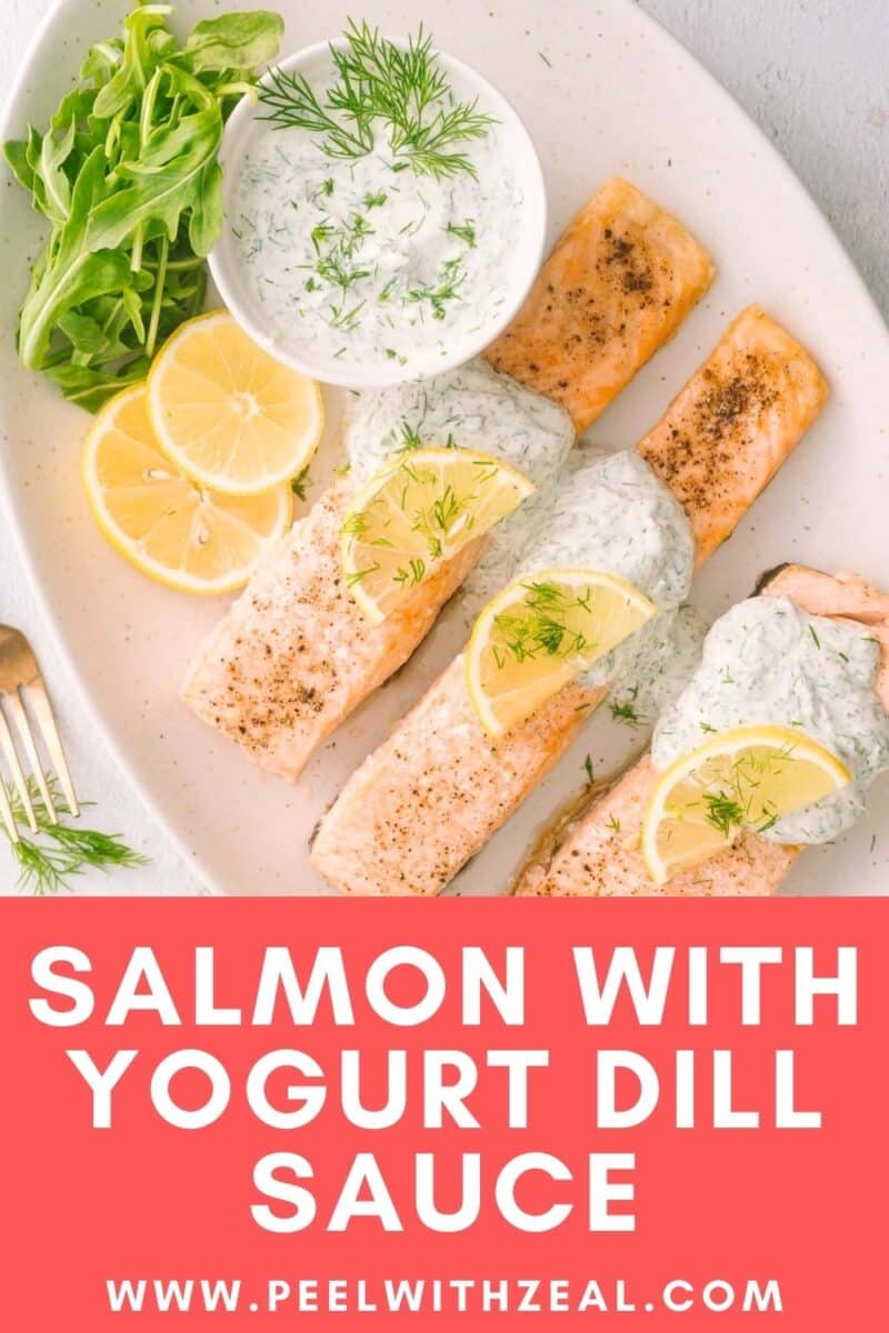 Salmon yogurt with dill sauce garnished with lemon slices served on the white platter.