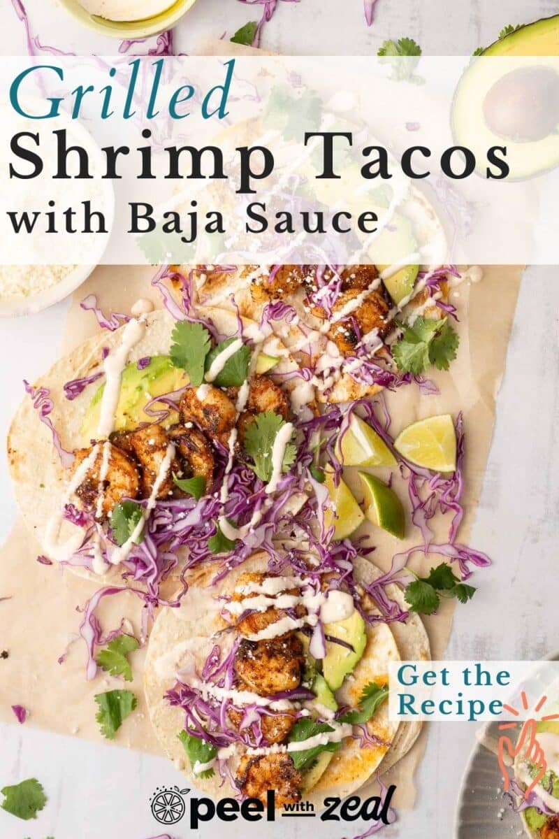 Grilled shrimp tacos with Baja sauce resting on the table.