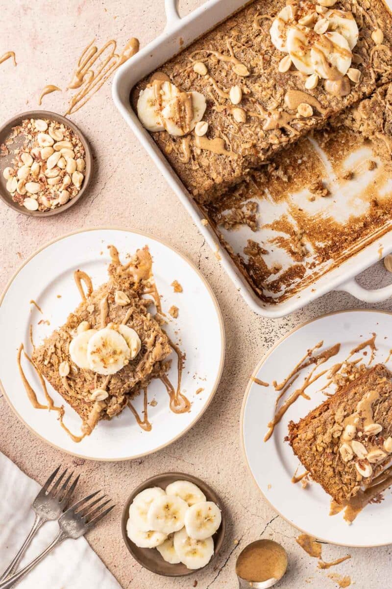 Baked Oatmeal peanut butter topped with nuts and banana drizzled with peanut sauce.
