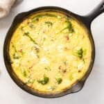 Broccolini Fritata creamy cheese on a skillet.