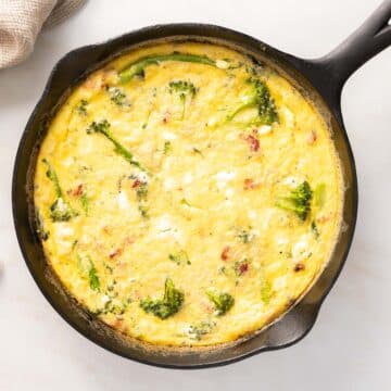 Broccolini Fritata creamy cheese on a skillet.
