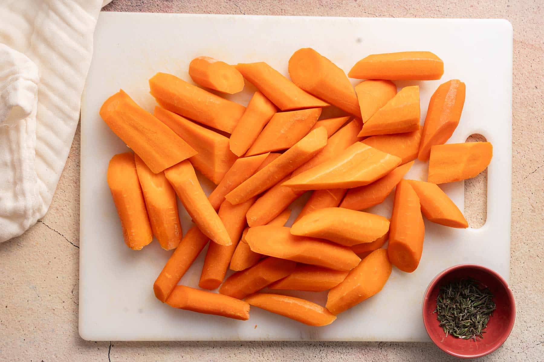 A slices of Carrots placed on a cutting board.