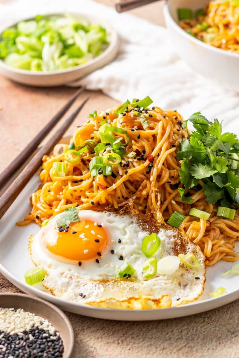 A portion of easy Miso Noodle served with a fried egg on a dinner plate.