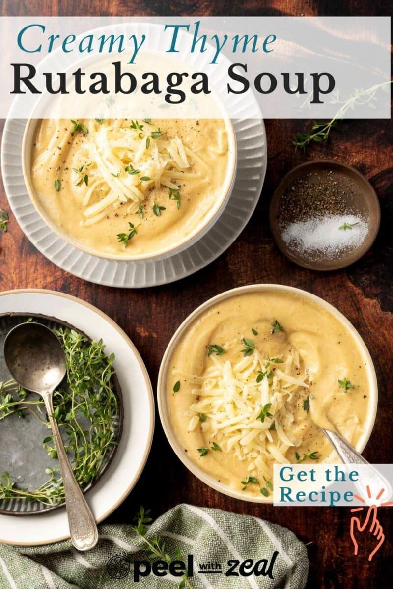 Two bowls of rich, creamy thyme rutabaga soup topped with grated cheese and thyme sprigs sit enticingly. A small dish of pepper and salt accompanies them. Text reads "Creamy Thyme Rutabaga Soup" and "Get the Recipe.