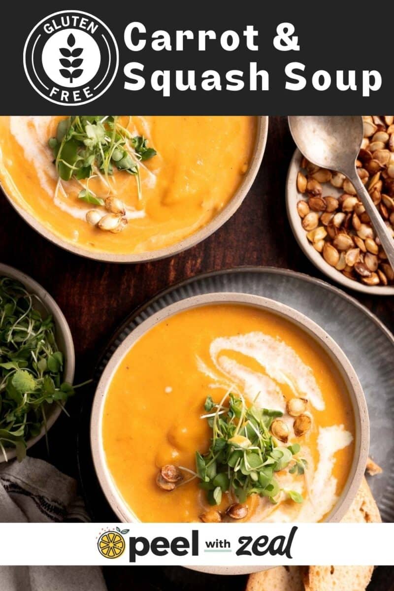 Carrot squash soup in a bowl with a swirl of cream.