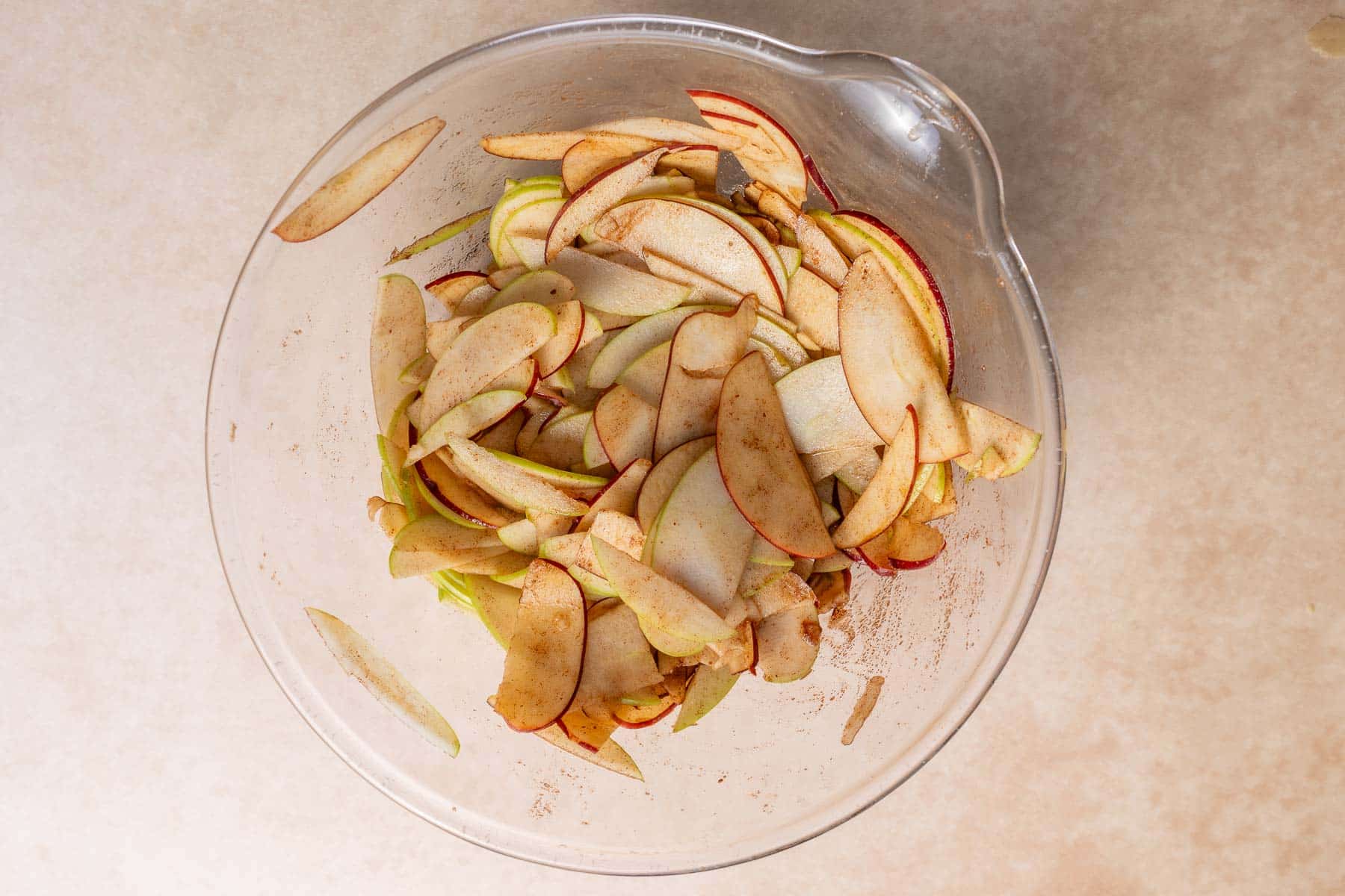 Coating the apples in brown sugar.