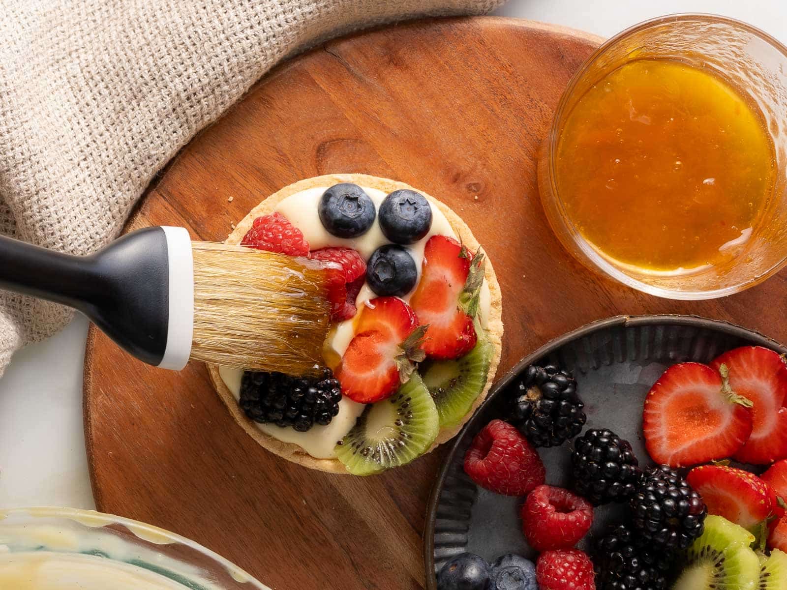 Brushing the glaze on the fruit.