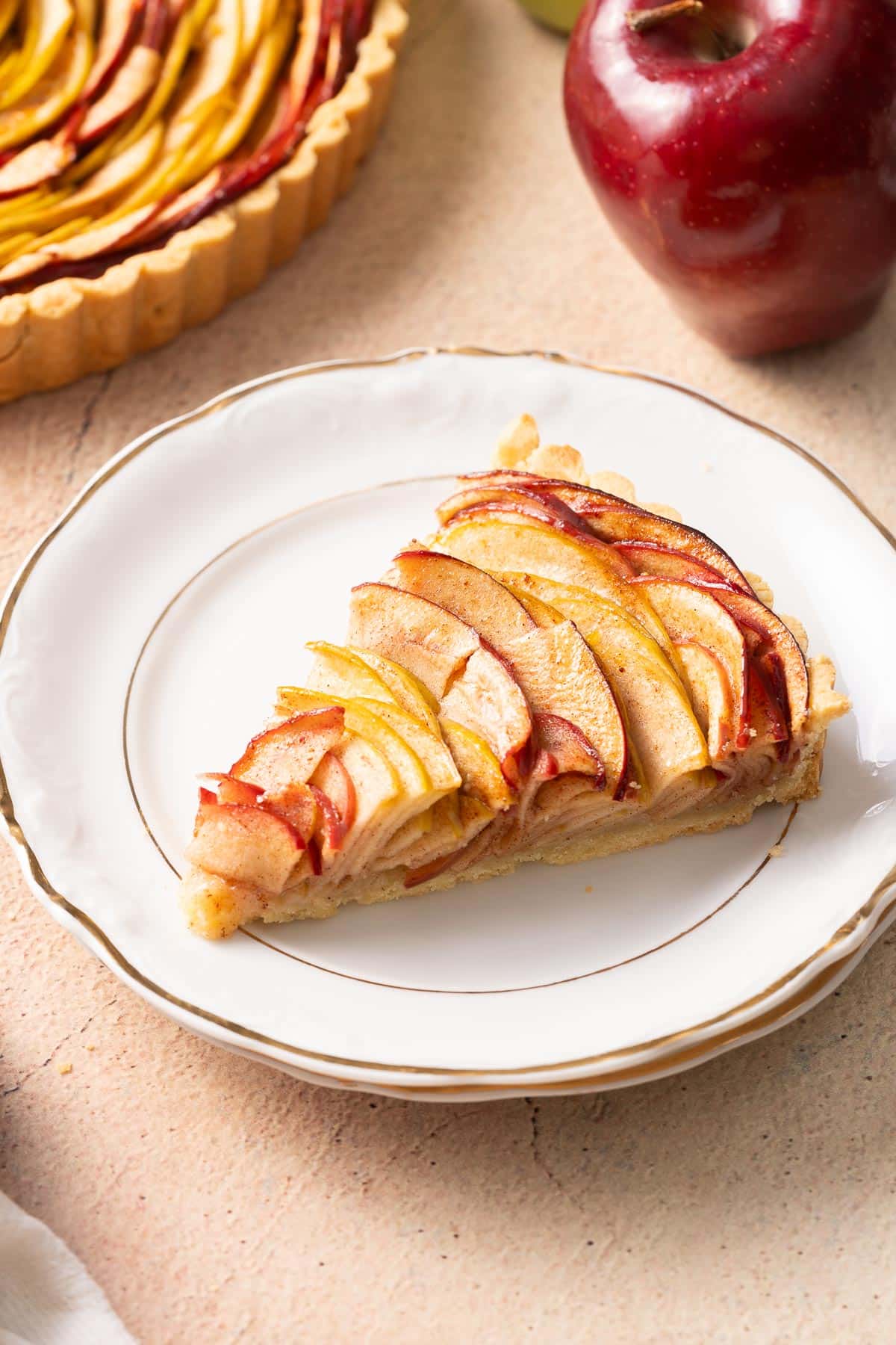 Slice of gluten free apple tart on a plate.