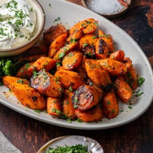Harissa roasted carrots on a serving platter.