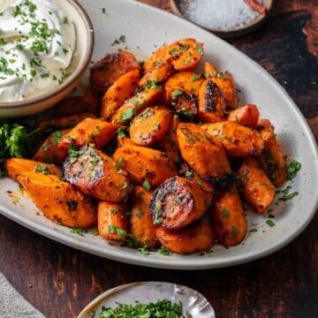Harissa roasted carrots on a serving platter.