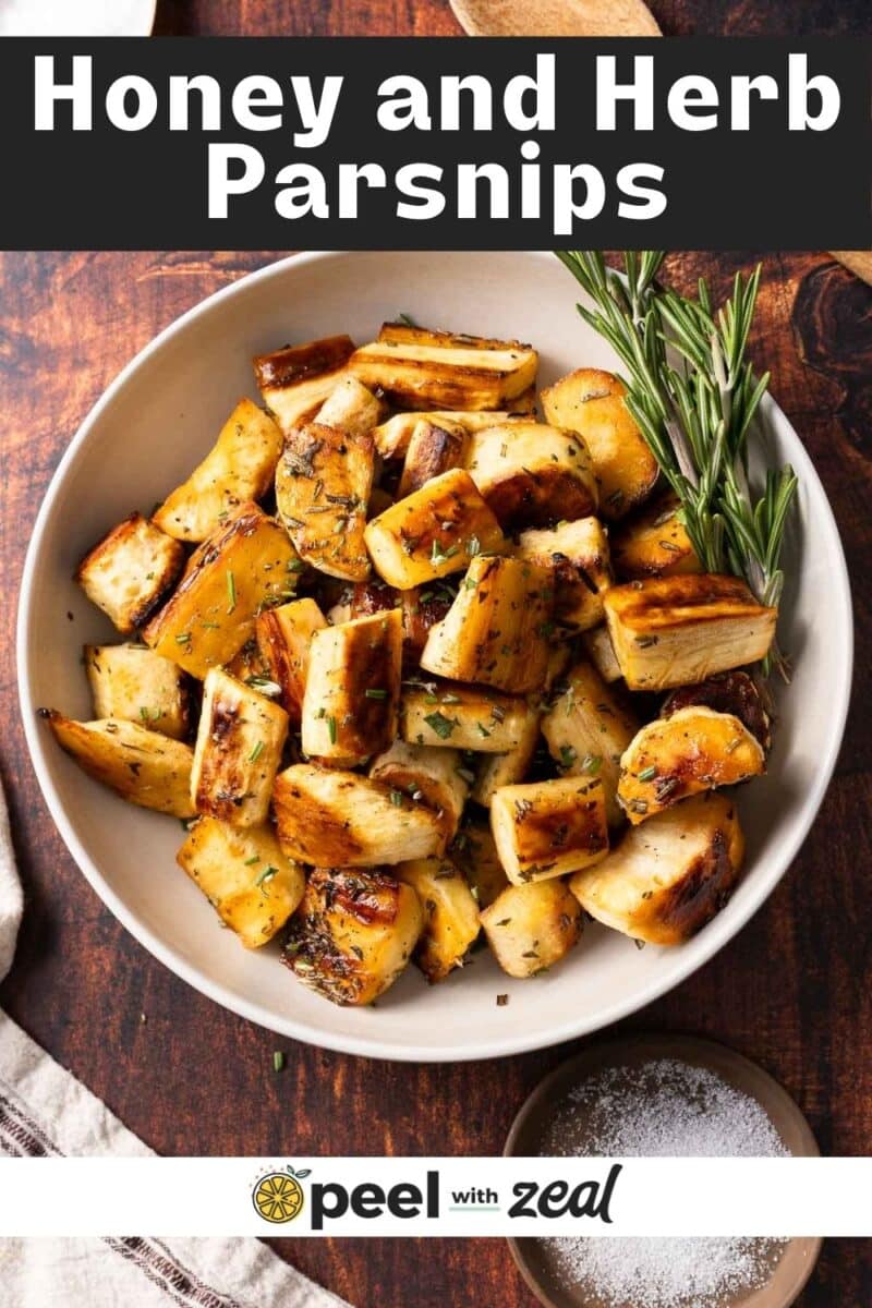 Honey parsnips in a bowl with herbs.