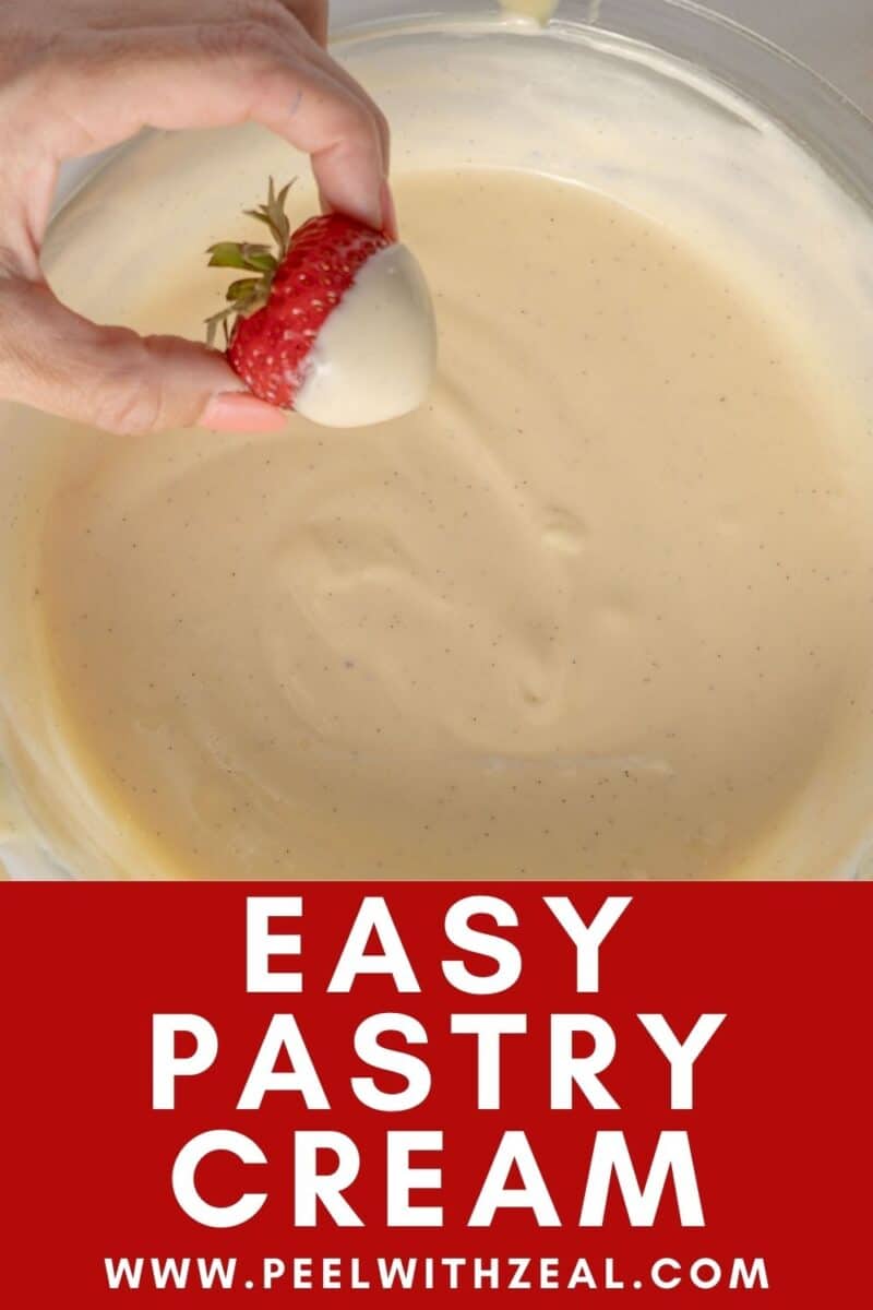 Dipping a strawberry into pastry cream.