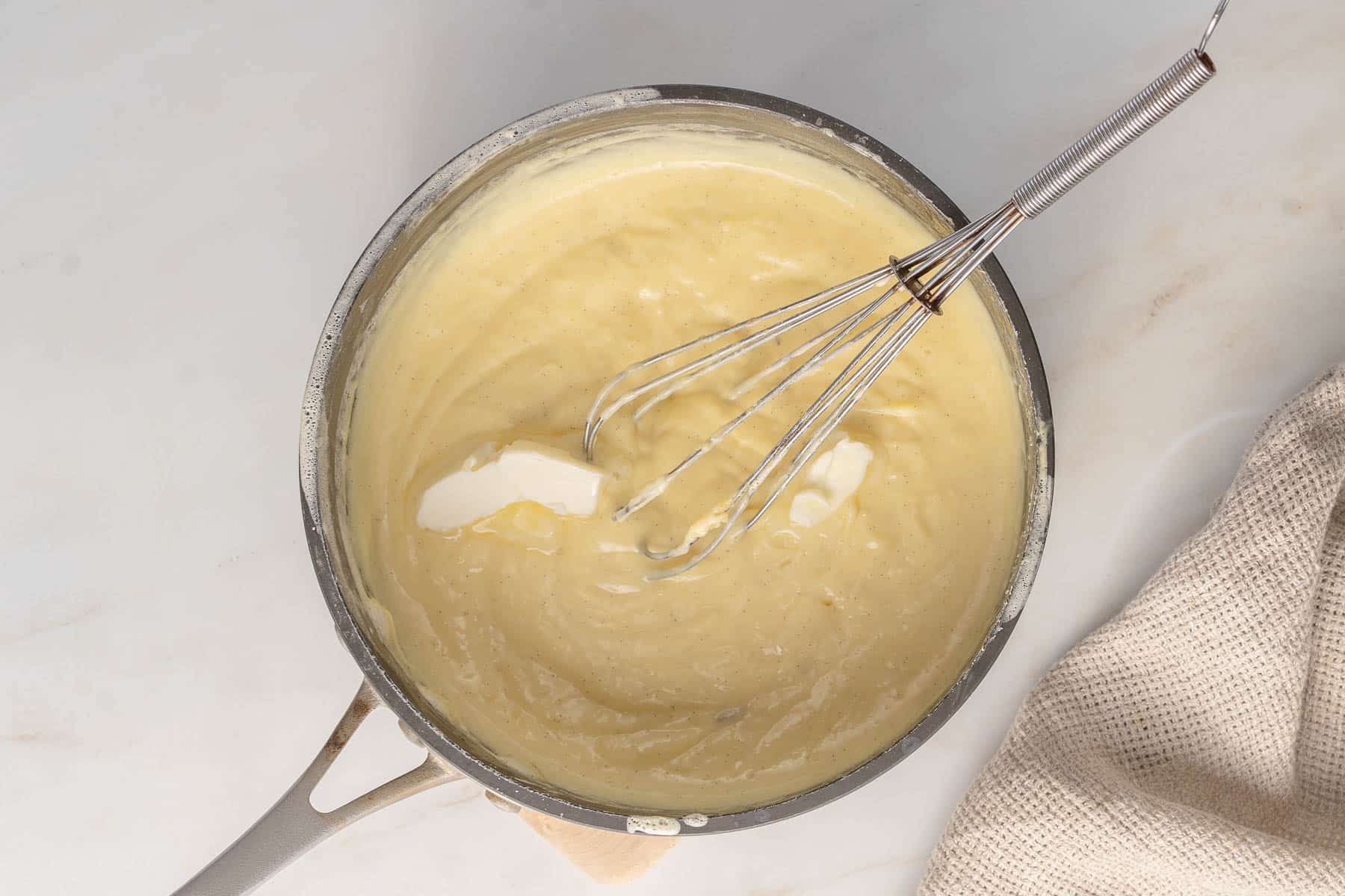 Stirring butter into pan.