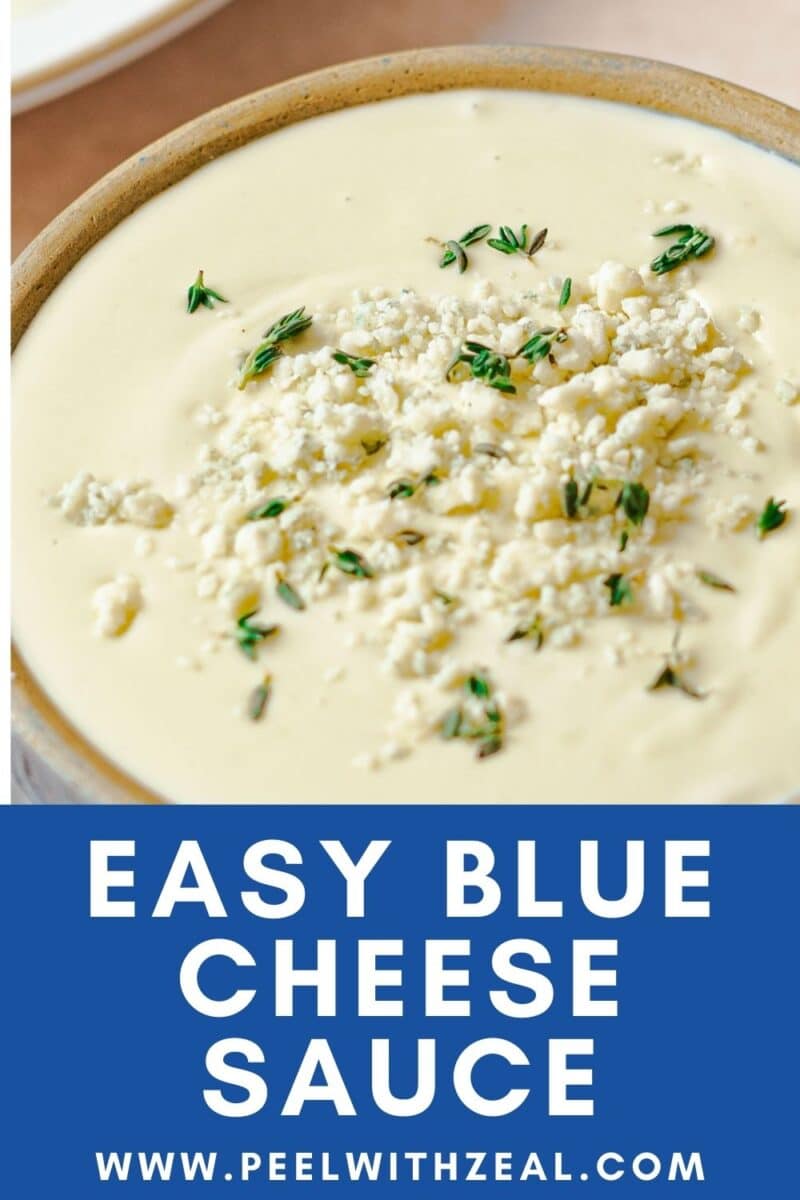 Bowl of creamy blue cheese sauce topped with crumbled cheese and herbs. Text below reads, "Easy Blue Cheese Sauce www.peelwithzeal.com".