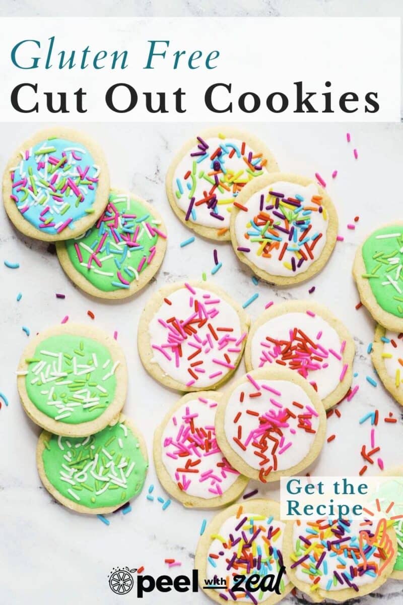 Assorted gluten-free cookies with green and white icing, topped with colorful sprinkles, scattered on a light surface. Text reads: "Gluten Free Cut Out Cookies.