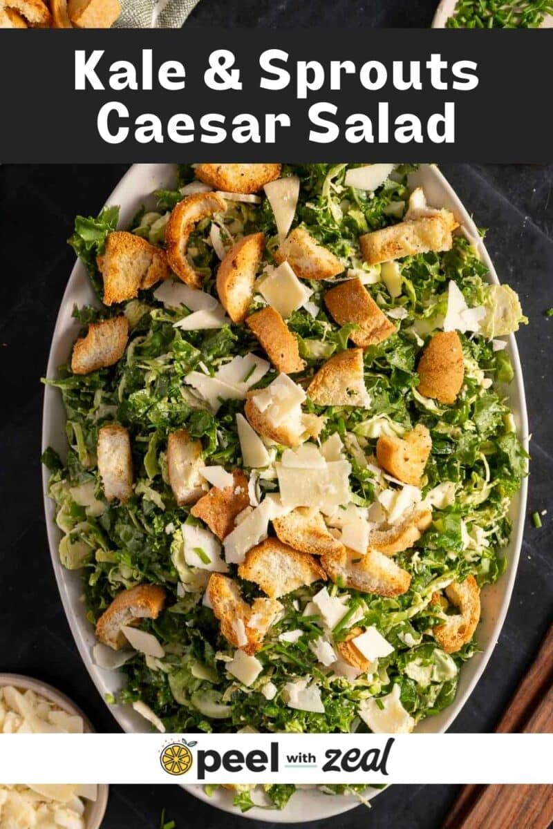 A plate of brussels sprout Caesar salad, featuring kale, topped with crunchy croutons and parmesan cheese.